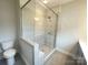 Tiled shower and modern fixtures in this bathroom at 266 Gilead Rd, Huntersville, NC 28078