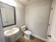Well-lit half bathroom featuring a stylish pedestal sink, and modern fixtures at 266 Gilead Rd, Huntersville, NC 28078