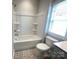 Bathroom featuring a tub and shower combination with decorative tile flooring at 266 Gilead Rd, Huntersville, NC 28078