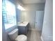 Bathroom with a single sink vanity, decorative tile flooring, and a well-lit mirror at 266 Gilead Rd, Huntersville, NC 28078