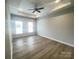 Bright bedroom featuring tray ceilings and a large window at 266 Gilead Rd, Huntersville, NC 28078