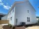 Side view of a two-story home, showcasing its light blue siding and multiple windows at 266 Gilead Rd, Huntersville, NC 28078