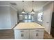Kitchen island featuring quartz countertops and pendant lighting, open to a spacious living area at 266 Gilead Rd, Huntersville, NC 28078