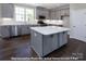 Modern kitchen with gray cabinets, white quartz countertops, and island at 266 Gilead Rd, Huntersville, NC 28078