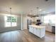 Bright, open kitchen with stainless steel appliances, a center island, and ample counter space at 266 Gilead Rd, Huntersville, NC 28078