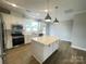 Modern kitchen with stainless steel appliances, large island, and bright lighting at 266 Gilead Rd, Huntersville, NC 28078