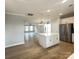 Modern kitchen with stainless steel appliances and island seating flows into the living space at 266 Gilead Rd, Huntersville, NC 28078