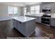 Modern kitchen with gray cabinets, white quartz countertops, and island at 266 Gilead Rd, Huntersville, NC 28078