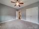 Well-lit bedroom with neutral walls, ceiling fan, and double door closet at 2836 Santiago Cir, Monroe, NC 28110