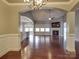 Open dining room with hardwood floors, looking toward the living room at 2836 Santiago Cir, Monroe, NC 28110