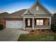 Brick ranch home with a two-car garage and landscaped front yard at 2836 Santiago Cir, Monroe, NC 28110