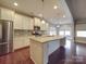 Large kitchen island with granite countertop and ample seating at 2836 Santiago Cir, Monroe, NC 28110