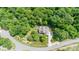 Aerial view of house nestled in a wooded area with a large lot and driveway at 3196 Stonemill Path, Sherrills Ford, NC 28673