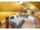 Upstairs bedroom with sloped ceiling, plush carpet, and ample natural light at 3196 Stonemill Path, Sherrills Ford, NC 28673