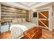 Main bedroom with barn door and wood-like wall accents at 3196 Stonemill Path, Sherrills Ford, NC 28673