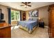 Spacious bedroom with carpeted floor, ceiling fan, and large window at 3196 Stonemill Path, Sherrills Ford, NC 28673