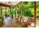 Covered patio with wicker furniture and wooded views at 3196 Stonemill Path, Sherrills Ford, NC 28673