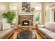 Cozy living room featuring a stone fireplace, hardwood floors, and ample natural light at 3196 Stonemill Path, Sherrills Ford, NC 28673