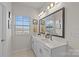 Double vanity bathroom with large mirror and window at 4020 Harmony Hills Dr, Matthews, NC 28104