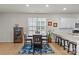 Kitchen dining area with four chairs, a plant, and blue area rug at 4020 Harmony Hills Dr, Matthews, NC 28104