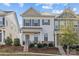 Two-story townhome with gray and beige exterior, landscaping, and walkway at 4020 Harmony Hills Dr, Matthews, NC 28104