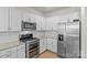 Modern kitchen with stainless steel appliances and white cabinets at 4020 Harmony Hills Dr, Matthews, NC 28104