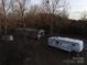 Aerial view of a mobile home and RV on a wooded lot at 4126 Oxford School Rd, Catawba, NC 28609