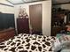 Bedroom with a dresser, TV, and a cow print comforter at 4126 Oxford School Rd, Catawba, NC 28609