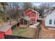 Aerial view of a red house with a backyard, shed, and screen porch at 423 Solomon St, Charlotte, NC 28216