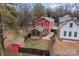 Aerial view of a red house with a backyard, shed, and screen porch at 423 Solomon St, Charlotte, NC 28216