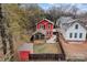 Aerial view of a red house with a backyard, shed, and screen porch at 423 Solomon St, Charlotte, NC 28216