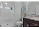 Clean bathroom with white tile shower, granite vanity, and window at 423 Solomon St, Charlotte, NC 28216