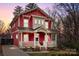 Beautiful two-story red house with a front porch and landscaped yard at 423 Solomon St, Charlotte, NC 28216