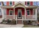 Charming front porch with white railings and American flag at 423 Solomon St, Charlotte, NC 28216