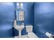 Stylish powder room with a pedestal sink, blue walls, and a gold mirror at 4419 Halstead Dr, Charlotte, NC 28209