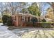 Brick Ranch home with landscaping and snowy yard at 4419 Halstead Dr, Charlotte, NC 28209