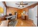 Spacious home office with wood paneled walls, hardwood floors, and ample natural light at 4419 Halstead Dr, Charlotte, NC 28209