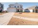 Two-story home with white siding, a two-car garage, and a well-maintained lawn at 450 Caleb St, Monroe, NC 28110