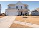 Two-story house with white exterior, two-car garage, and front porch at 450 Caleb St, Monroe, NC 28110