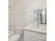 Modern bathroom features a white vanity with quartz countertop and a tiled shower with glass door at 5048 York Park Ln, Charlotte, NC 28217