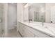 Stylish bathroom featuring double sinks, quartz countertops, and a glass-enclosed shower at 5048 York Park Ln, Charlotte, NC 28217