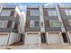 Modern townhome with gray and wood accents, a single-car garage, and a rooftop deck at 5048 York Park Ln, Charlotte, NC 28217