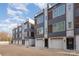 Modern townhomes with sleek exteriors, featuring multi-story design, garages, and individual entryways at 5048 York Park Ln, Charlotte, NC 28217