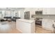 Bright kitchen with quartz island, stainless steel appliances, open to the living room at 5048 York Park Ln, Charlotte, NC 28217