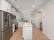 Bright kitchen featuring stainless steel appliances, a center island, and hardwood floors at 5048 York Park Ln, Charlotte, NC 28217