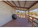 View of the back porch with wood floors and railing. Also shown is a grill at 535 5Th St, Chester, SC 29706