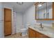 Well-lit bathroom featuring a shower, vanity, and storage cabinet at 535 5Th St, Chester, SC 29706