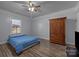 Bedroom with hardwood floors, ceiling fan, and built-in wardrobe at 535 5Th St, Chester, SC 29706