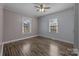 This bedroom offers hardwood floors, neutral paint, natural light through 2 windows, and a ceiling fan at 535 5Th St, Chester, SC 29706
