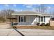 Cozy single-story home with a covered porch, black shutters, and tidy front yard at 535 5Th St, Chester, SC 29706